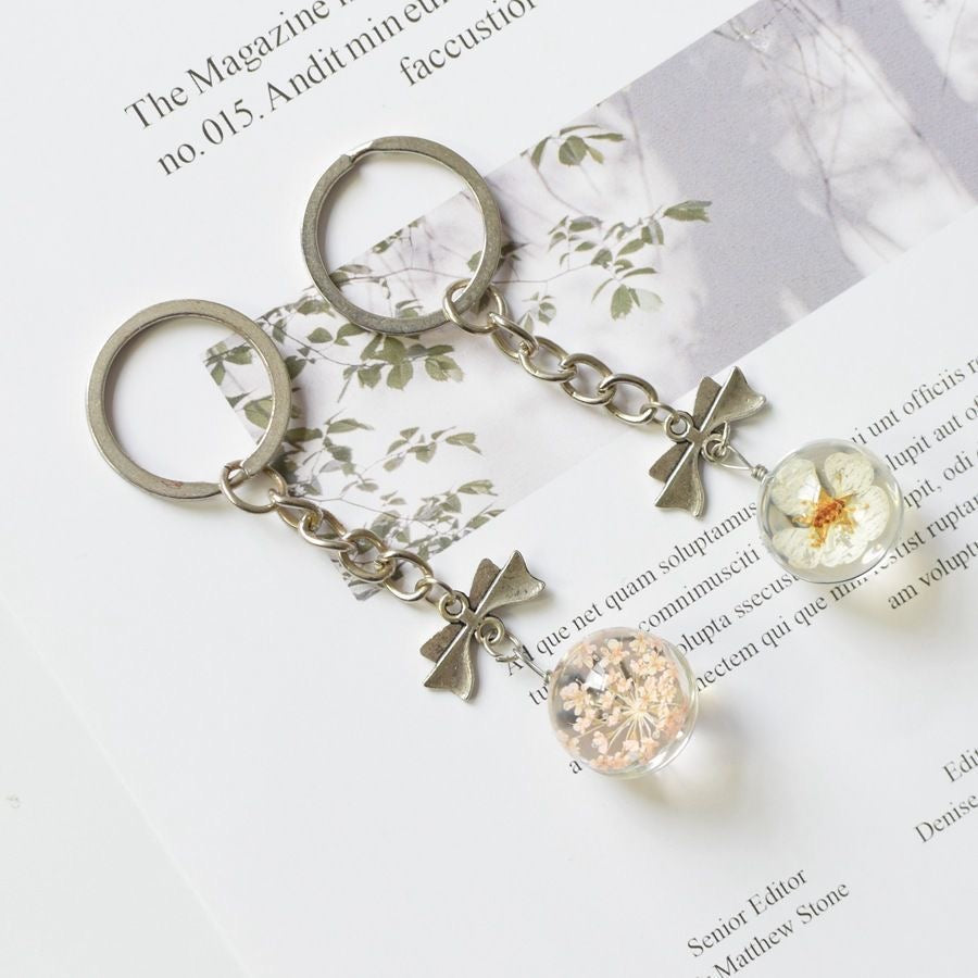 Handmade eternal flower glass orb keychain with preserved yellow gypsophila inside resin sphere