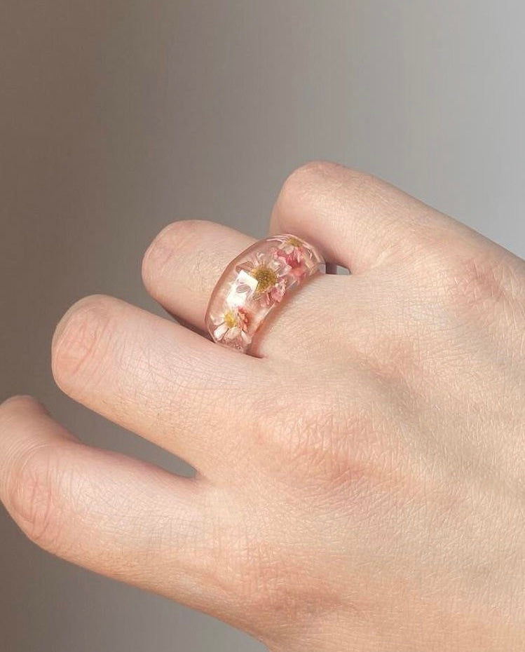 Close-up of daisy resin ring showing natural flower details