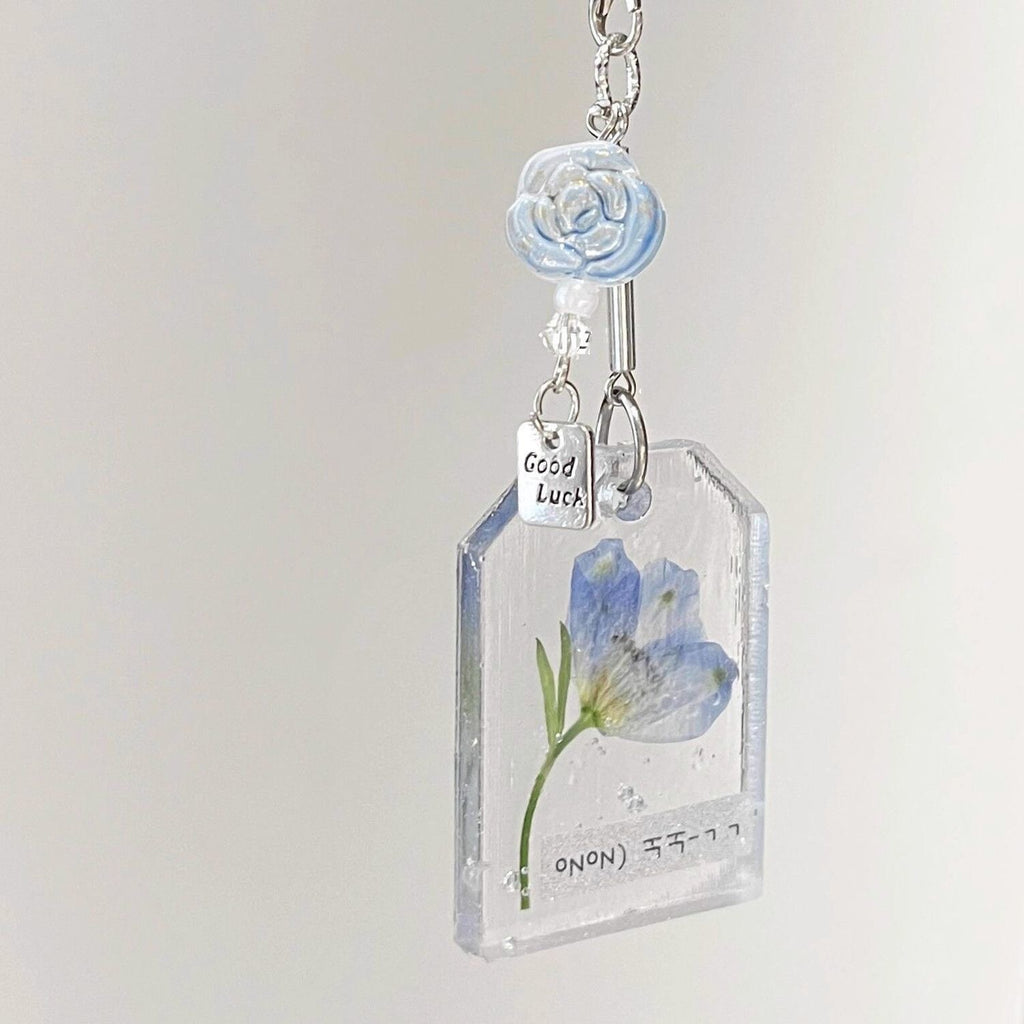 Blue swallow flower resin keychain with Good Luck charm